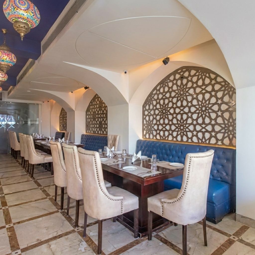Pankhuri dining tables beneath decorative arches and lamps