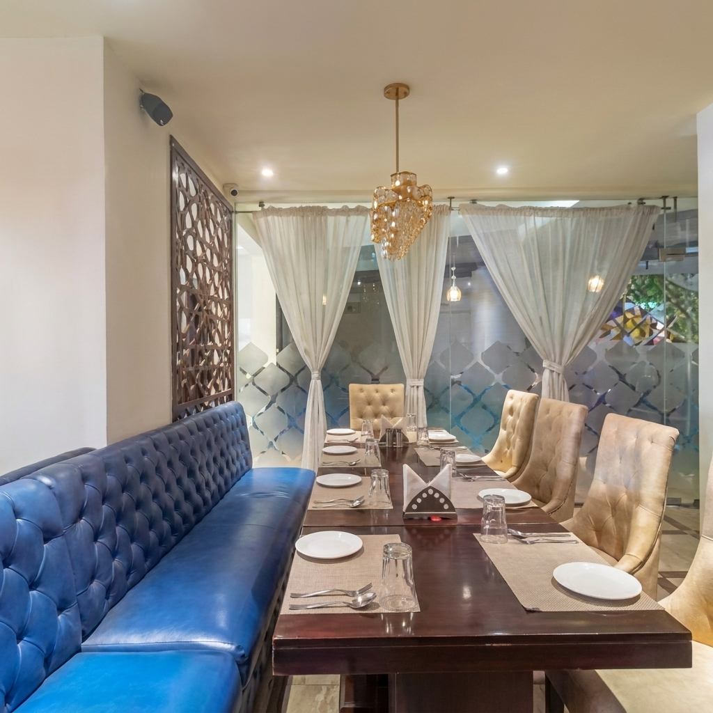 Large family dining table with booth and chair seating at Pankhuri